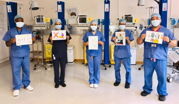 Staff holding thank you pictures